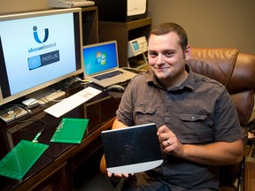 Brad Young, of Ideas Unlimited, shows off Motus, an open source hands-free controller, in the basement of his home in London on Tuesday. (CRAIG GLOVER/QMI Agency)