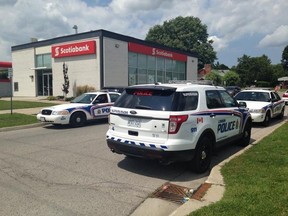 London police cruisers were parked outside a Scotiabank at Hamilton Rd. and Highbury Ave. Thursday afternoon after an armed suspect fled with an unknown quantity of cash. JENNIFER BIEMAN / THE LONDON FREE PRESS