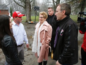 River Road resident in Corbyville, Ont., north of Belleville, Ont., Derick Swoffer, second from left, speaks with Ontario Premier Kathleen Wynne and Mayor of Belleville Neil Ellis, right, during a tour of flooded areas on April 22, 2014. - File photo by Jerome Lessard/The Intelligencer/QMI Agency