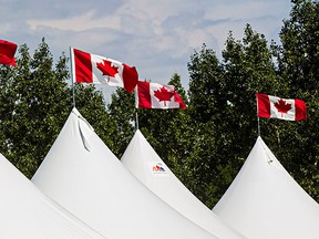 Canada flags flap in the wind during set up for Heritage Festival at Hawrelak Park in Edmonton, Alta., on Thursday, July 31, 2014. Heritage Festival runs from August 2-4. Codie McLachlan/Edmonton Sun/QMI Agency