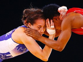 Brittanee Laverdure of Canada (left) and Ifeoma Nwoye of Nigeria grapple during their women's freestyle 55kg wrestling semifinal at the Commonwealth Games in Glasgow, Scotland, on Thursday, July 31, 2014. (Andrew Winning/Reuters)