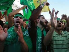 Palestinian Hamas supporters shout slogans against Israel during a protest to support Hamas and against the Israeli offensive on Gaza strip, in the West Bank city of Nablus July 31, 2014. (REUTERS/Abed Omar Qusini)