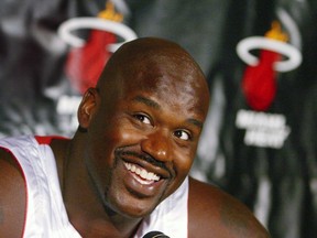 Miami Heat center Shaquille O'Neal smiles at the press, during media day in Miami, Florida, in this October 4, 2004 file photo. (REUTERS/Marc Serota/Files)