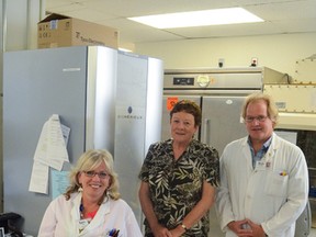 Sam Miller, from left, Jenny Raymond and Rob Kendrick pose in front of the new mass spectrometer purchased by the KGH Auxiliary.