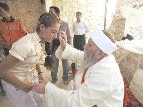 A Yezidi religious leader blesses a worshipper during the community?s main festival of Eid al-Jamma in this 2010 photo taken at Lalish temple in a small mountain valley 390 kilometres northwest of Mosul, Iraq. Members of London?s Yezidi community recently held a rally to raise awareness of the plight of families living in Iraq. (Reuters)