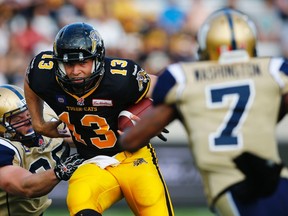 Tiger-Cats quarterback Dan LeFevour runs the ball against the Blue Bombers on Thursday night. (Mark Blinch/Reuters)