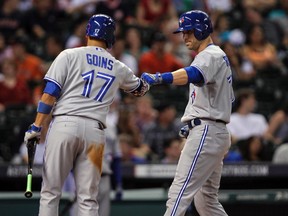Toronto Blue Jays designated hitter Nolan Reimold (14) is congratulated by second baseman Ryan Goins (17) after hitting a home run during the fifth inning against the Houston Astros at Minute Maid Park on Jul 31, 2014 in Houston, TX, USA. (Troy Taormina/USA TODAY Sports)
