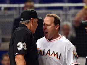Miami Marlins manager Mike Redmond (center) argues with home plate umpire Mike Winters (left) during the eighth inning against the Cincinnati Reds at Marlins Ballpark on Jul 31, 2014 in Miami, FL, USA. (Steve Mitchell/USA TODAY Sports)