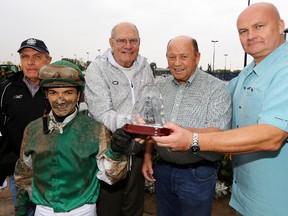 John Short (centre) presents (left to right) Dale Saunders, Fernando Perez, Pat Schaffer, and Charlie Garvey with the Sun Sprint trophy, after Ready Racer won the 37th Running of The Sun Sprint Championship in  September 2013. David Bloom/Edmonton Sun