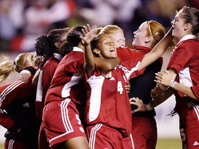 Edmonton Alta. Aug. 29, 2-002. Sasha Andrews is mobbed after scoring the winning goal in the penalty kick format after Canada and Brazil had tied 1-1 following regulation and two sudden-death overtime periods in last night's FIFA U-19 Women's World Soccer Championships semi-finals at Commonwealth Stadium. Perry Mah/Edmonton Sun/QMI Agency