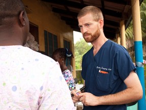 Dr. Kent Brantly, right, speaks with colleagues at the case management center on the campus of ELWA Hospital in Monrovia, Liberia in this undated handout photograph courtesy of Samaritan's Purse. (REUTERS/Samaritan's Purse/Handout via Reuters)