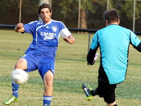 Wallaceburg Sting senior men's soccer player Kyle Allaer tries to break up the London English goalie's clearing attempt, during a game held at Kinsmen Park on July 31. The final score ended up being 1-1, with Kurtis Lubbers scoring the Sting's goal. The Sting now have a record of 6-3-4, for 22 points. and currently hold down second place in the Western Ontario Soccer League First Division. The next game for the Sting is Wed., Aug. 6 in Tillsonburg while the Sting's next and last home game is Aug. 12 against Middlesex.