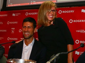 Novak Djokovic and Lesley Tayles, National Bank VP of Personal Banking Ontario, help perform the Rogers Cup draw on Aug. 1. (Dave Abel, Toronto Sun)
