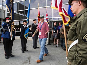 Veterans, caregivers and first responders make their way to waiting buses at the Edmonton International Airport in Leduc, Alta., on Friday, Aug. 1, 2014. A cavalcade with some 175 veterans, caregivers and first responders from Canada, Australia, England, the United States along with special guest Miss World, Megan Young, will be driving from the Edmonton International Airport to Slave Lake to take part in the Wounded Warriors Weekend from August 1st to 5th. The soldiers will take part in several free activities, including fishing, golf, BBQ, Gala Dinner and much more. More information on the weekend’s events can be found at www.woundedwarriorsweekend.com.  Codie McLachlan/Edmonton Sun/QMI Agency