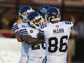 Argos running back Steve Slaton celebrates one of his two touchdowns in Montreal on Friday night. (REUTERS)