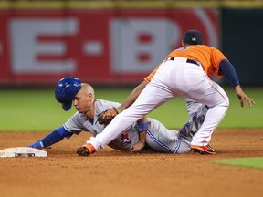 Blue Jays second baseman Ryan Goins is out at second base on an attempted steal as Astros second baseman Gregorio Petit applies the tag during fifth inning MLB action in Houston on Friday, Aug. 1, 2014. (Troy Taormina/USA TODAY Sports)