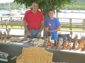 Bonnie Kogos/For The Sudbury Star
Woodcarver John Macdonald and his young helper at the busy Friday Gore Bay Market.