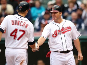 Cleveland Indians' Shelley Duncan (47) shakes hands with teammate Jim Thome after hitting his second two run homerun of the game against the Detroit Tigers. REUTERS/Aaron Josefczyk