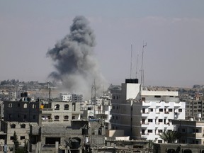 Smoke rises following what witnesses said was an Israeli air strike in Rafah in the southern Gaza Strip Aug. 3, 2014.  REUTERS/Ibraheem Abu Mustafa