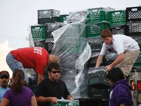 Volunteers unload drinking water from a truck outside Waite High School in Toledo, Ohio Aug. 3, 2014. REUTERS/JOSHUA LOTT