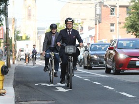 Councillor Denzil Minnan-Wong (front) unveils bike lanes on Adelaide St. last week. (STAN BEHAL, Toronto Sun)