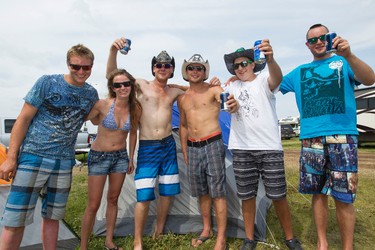 Steve Wurz (centre) from Silvan Lake, Alta., poses for a photo with his friends during Big Valley Jamboree 2014 in Camrose, Alta., on Sunday, Aug. 3, 2014. Ian Kucerak/Edmonton Sun/QMI Agency