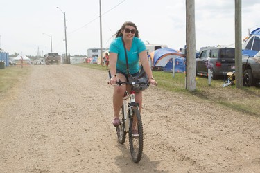 Christina Reid, with the Love To Recycle Team, rides her bicycle during Big Valley Jamboree 2014 in Camrose, Alta., on Sunday, Aug. 3, 2014. Ian Kucerak/Edmonton Sun/QMI Agency