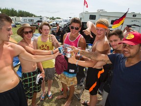 Partiers from St. Albert, Alta., pose for a photo at their campsite during Big Valley Jamboree 2014 in Camrose, Alta., on Sunday, Aug. 3, 2014. Ian Kucerak/Edmonton Sun/QMI Agency