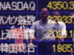 A man is reflected on an electronic board showing market indices of the (top-bottom) NASDAQ, Hong Kong Hang Seng Index, SSE Composite Index, and Korea Composite Stock Price Index outside a brokerage.

REUTERS/Yuya Shino
