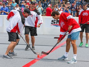 Toronto Maple Leafs' Phil Kessel and Roger Federer face-off in a game of ball hockey on Sunday, Aug. 3, 2014. (Dave Thomas/Toronto Sun/QMI Agency)