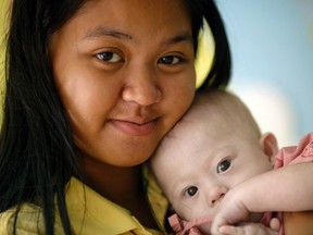 Gammy, a baby born with Down's Syndrome, is held by his surrogate mother Pattaramon Janbua at a hospital in Chonburi province on August 3, 2014. (REUTERS/Damir Sagolj)