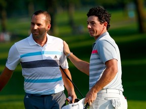 Sergio Garcia of Spain congratulates Rory McIlroy of Northern Ireland on his win after putting on the 18th green during the final round of the World Golf Championships-Bridgestone Invitational at Firestone Country Club South Course on August 3, 2014 in Akron, Ohio.  (Sam Greenwood/Getty Images/AFP)