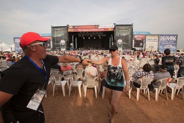 A couple dances the two step as Marty Stuart performs on the main stage during Big Valley Jamboree 2014 in Camrose, Alta., on Sunday, Aug. 3, 2014. Ian Kucerak/Edmonton Sun/QMI Agency
