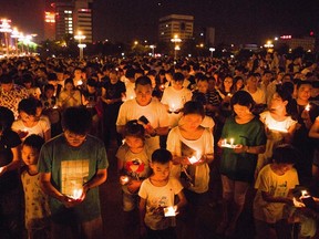 Residents gather as they attend a candlelight vigil for victims of a factory explosion, in Kunshan, Jiangsu province Aug. 2, 2014.  REUTERS/Stringer
