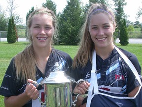 Sara Svoboda and Katie Svoboda, of Belleville, with the NWL Cup, symbolic of women's rugby supremacy in Canada, following Ontario's 27-10 win over B.C. Sunday at Twin Elm Rugby Park in Nepean.