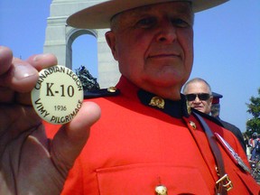 Retired RCMP Staff Sgt. Garth Hampson of Blackburn Hamlet keeps a button belonging to his father, L/Cpl Sid Hampson, who was with the 10th Battalion, close to his chest. Kelly Roche/Ottawa Sun