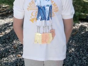 Swimmer Avery Wiseman shows off the three gold and three bronze medals she won at the recent Alberta Summer Games held in Airdrie.