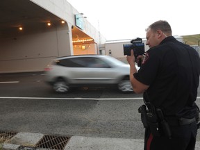 A Calgary police officer does speed enforcement at the tunnel on Airport Tr. in northeast Calgary, Alta. on Monday August 4, 2014. A police crackdown on street racing over the weekend at both the tunnel and on Stoney Tr. S.E. saw dozens of charges laid. 
Stuart Dryden/Calgary Sun/QMI Agency