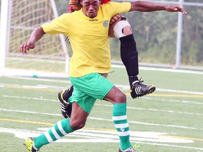 Mississauga AC Diavoli, Robert Covassin, heads the ball as Jelomi DeJonge of Scarborough City Celitc, keeps in close check during Sudbury Star Cup championship game action from James Jerome Field on Monday afternoon.