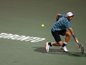 Peter Polansky of Canada returns a shot to Jerzy Janowicz of Poland during Rogers Cup at Rexall Centre at York University on August 4, 2014. (Ronald Martinez/Getty Images/AFP)