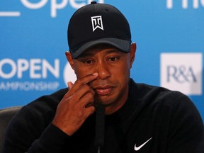 Tiger Woods of the U.S. listens to questions during a news conference ahead of the British Open Championship at the Royal Liverpool Golf Club in Hoylake, northern England July 15, 2014. (REUTERS/Cathal McNaughton)