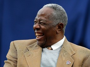 Hall of Famer Hank Aaron enjoys a laugh as he is honoured on the 40th anniversary of his 715th homer prior to the game between the Atlanta Braves and the New York Mets at Turner Field on April 8, 2014 in Atlanta, Georgia. (Kevin C. Cox/Getty Images/AFP)
