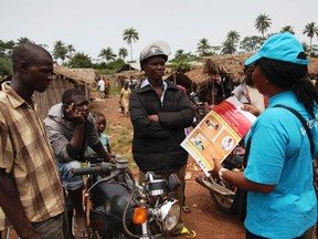 A UNICEF worker speaks with drivers of motorcycle taxis  about the symptoms of Ebola virus disease (EVD) and best practices to help prevent its spread, in the city of Voinjama, in Lofa County, Liberia in this April 2014 UNICEF handout photo. REUTERS/Ahmed Jallanzo/UNICEF/Handout via Reuters