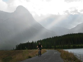 Chris Wickins goes for a bike ride under Ha Ling Peak in this 2010 file photo. (Pam Doyle/Canmore Leader)