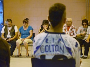 Jimmy Crowshoe hangs his head while listening to people share their memories of Colton. John Stoesser photo/QMI Agency.