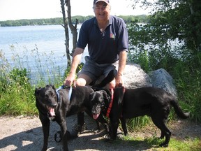 Writer Jim Fox with Cisco and Raven at dog-friendly Bass Lake Provincial Park near Orillia. (Barbara Fox photo)