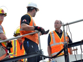 London Coun. Matt Brown (right) gets a safety lesson from CP Rail’s Dustin Ritter August 5, 2014 on top of a tank car near Rectory Street in London, Ont. Training exercises for emergency first responders are taking place in London between August 5 – 9. CHRIS MONTANINI\LONDONER\QMI AGENCY