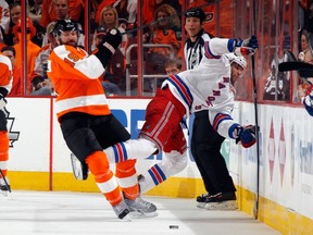 PHILADELPHIA, PA - APRIL 22: Scott Hartnell #19 of the Philadelphia Flyers takes a two minute penalty for boarding former Sudbury Wolves foward Benoit Pouliot #67 of the New York Rangers during the first period in Game Three of the First Round of the 2014 NHL Stanley Cup Playoffs at the Wells Fargo Center on April 22, 2014 in Philadelphia, Penn. A former American hockey player has invented the Look-Up Line to prevent such plays.