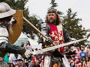 Sir Troy (Dolan), left, does battle with the rebellious Welsh Prince Owain Glyndwr (Tom Yohemas) at the Wales pavilion during Heritage Festival in Hawrelak Park in Edmonton, Alta., on Monday, Aug. 4, 2014. The Welsh Revolt was re-enacted by the Knights of the Northern Realm. Codie McLachlan/Edmonton Sun