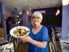 Betty Heydon holds farfalle with summer vegetables and black tiger shrimp at Blackfriar?s Bistro in London. (DEREK RUTTAN, The London Free Press)